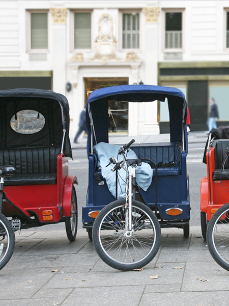 photo of three pedicabs on the street