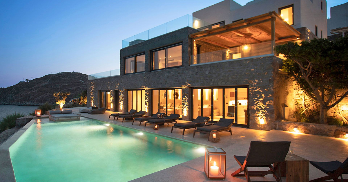 photo of a large modern villa in Greece at night, with a pool, from Villas of Distinction. 
